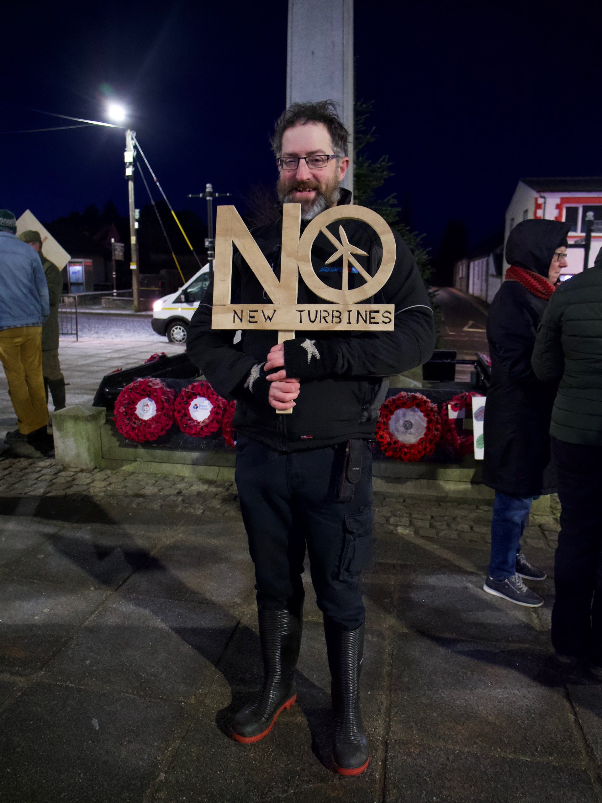 Demonstration Andrew Hockenhull holding his stencil no new turbines